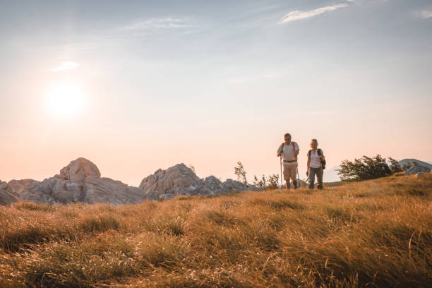 Two friends travelers enjoys a break look at the top of the mountain during the hike adventure travel. . High quality photo