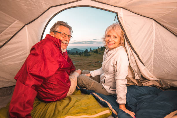 istock Smiling Senior Married Couple Camping Outdoors And Looking For Adventure 1410390157