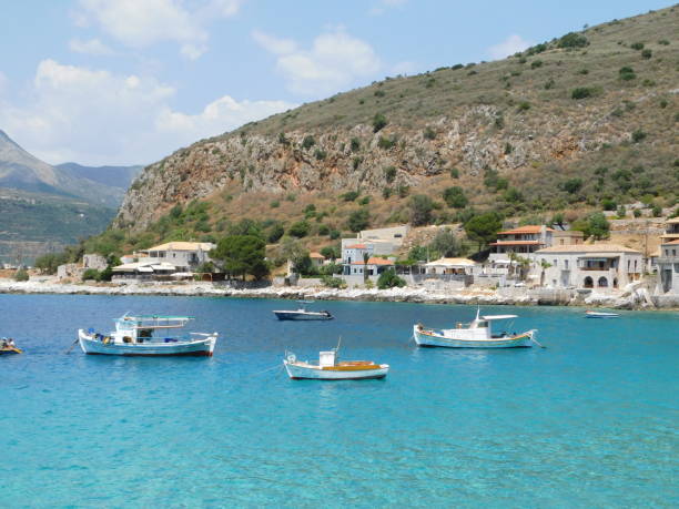 Fishing boats on a turquoise and blue sea, at Limeni, Mani, Greece
