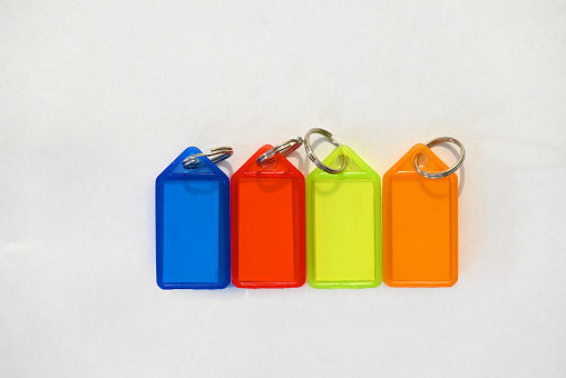 Four plastic key chain name tags of different colours