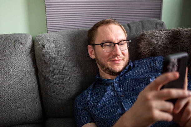 istock Man playing games on his smart phone 1410393525