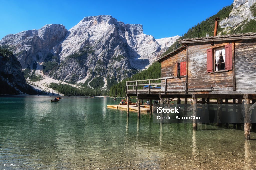 Lago di Braies Lago di Braies a famous landmark in Dolomites Italy in South Tyrol with a wooden hut. A small lake surrounded by mountain peaks. Alto Adige - Italy Stock Photo