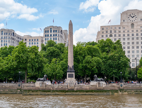 Cleopatra’s Needle on the Victoria Embankment beside the River Thames in the City of Westminster, London. It’s the Platinum Jubilee of Queen Elizabeth II and everyone is in celebratory mood, with Union flags flying everywhere.