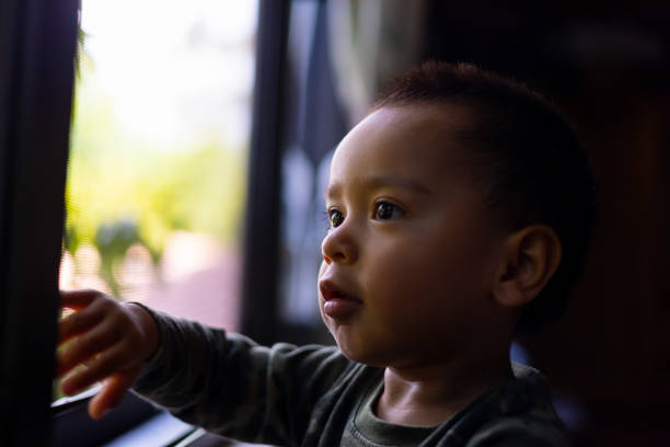 istock Infant looking out the window. 1410396555
