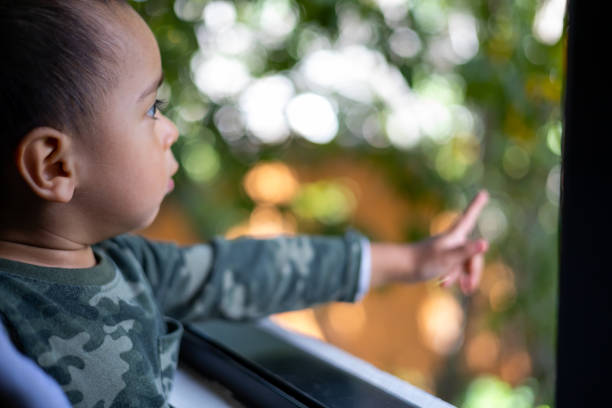 istock Infant looking out the window. 1410396566