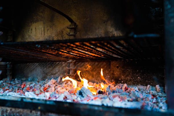 Charcoal burning under a grill at a barbecue.