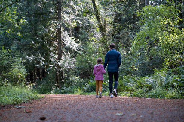 istock Mother and daughter hiking in a lush forest 1410399162