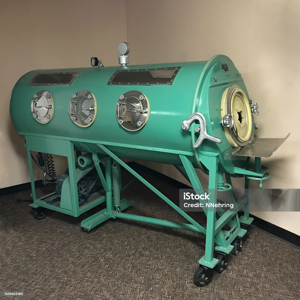 iron lung machine Iron lung on display at Tuskegee Institute National Historic Site, Tuskegee, Alabama, USA. Iron lungs were used to assist people paralyzed by polio to breath. Iron Lung Stock Photo
