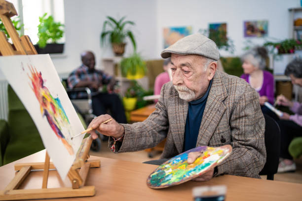 istock An elderly man wearing a flat cap is painting a picture 1410408269