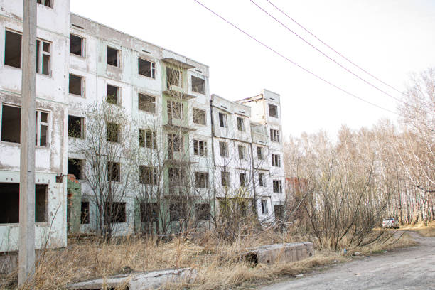 istock Dilapidated residential building with empty windows, collapsed roof, collapsed roof 1410410575