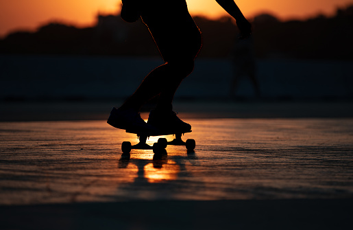 man skateboarding at sunset