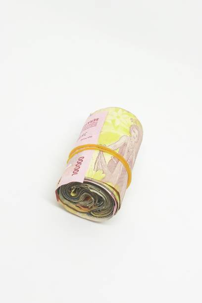istock Money rolled up and tied with rubber 1410415162