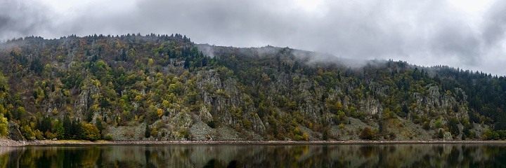 Lac Blanc, France, October 17, 2020: Panoramic view of Lac Blanc (White Lake) in the Vosges Mountains on a cloudy autumn day. At an elevation of 1055 m, its surface area is 0.29 km².