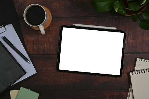 Businessman leaning on the table and working on digital tablet.