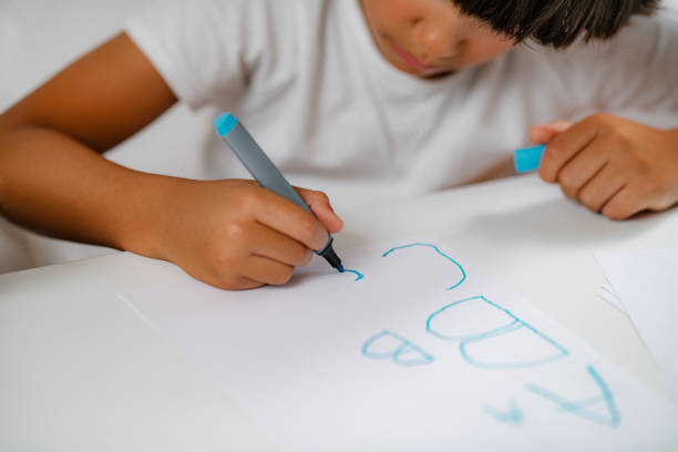istock Preschooler boy writing letters 1410421270