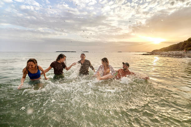 istock Splashing in the sea at sunset! 1410422447