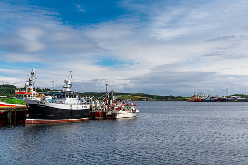 Killybegs, Ireland - 14 July, 2022: colorful fishing boats in the industrial fishing port of Killybegs