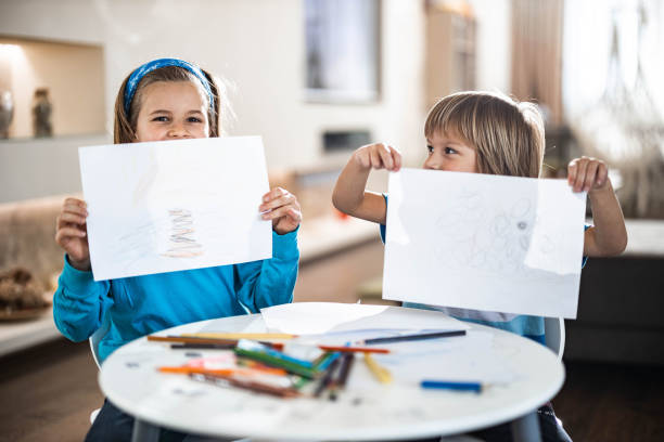 istock Happy boys showing their drawings at home. 1410423896