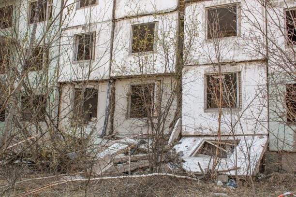 istock Dilapidated residential building with empty windows, collapsed roof, collapsed roof 1410424037