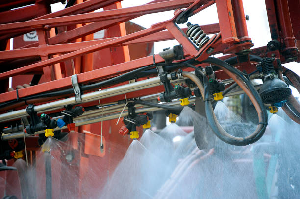 Spraying chemicals over crops stock photo