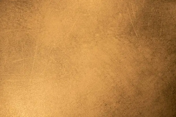 Photo of Abstract golden background, dirty and weathered grunge-style golden surface