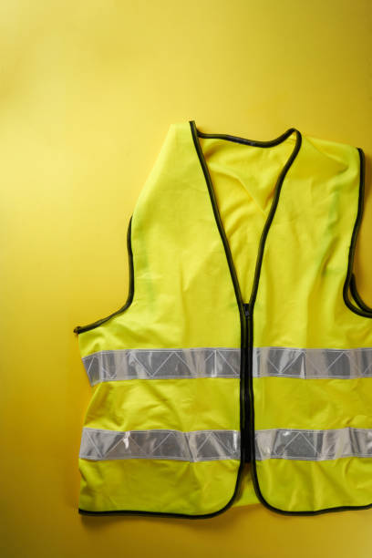 istock yellow reflective vest against yellow background 1410428327