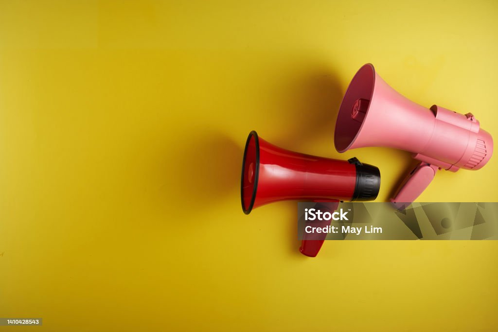 megaphone against yellow background Voice Stock Photo