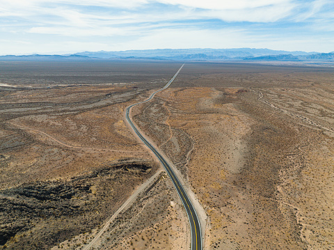 Aerial view of a road winding through desert landscape near Valley of Fire in Nevada, USA.