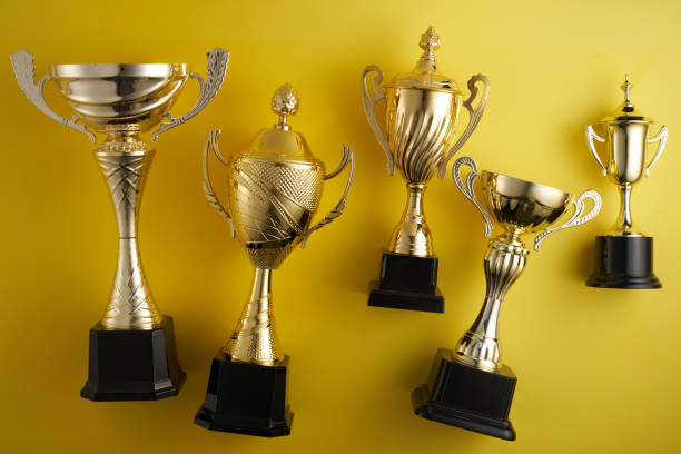 istock gold trophy against yellow background 1410428647