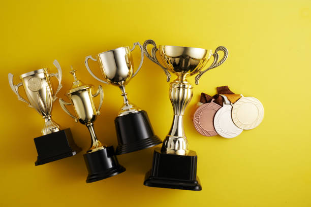 istock gold trophy against yellow background 1410429184