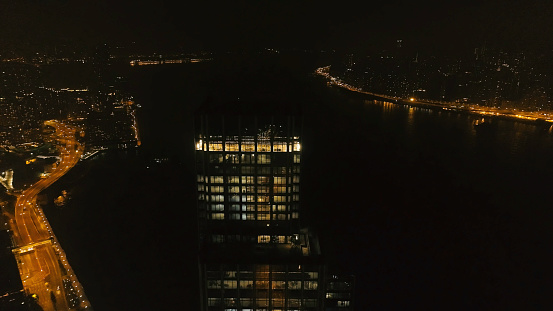 Top view of the skyscraper in Hong Kong at night. Stock. Beautiful view of the tall skyscraper in the Central business district in Hong Kong.