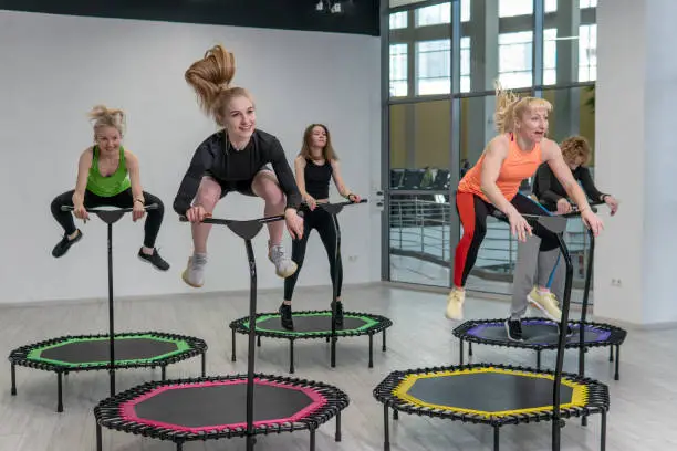 Fitness group center friends active trampoline youth health athlete young, for team female from healthy from gym happiness, loss teamwork. Woman studio action, smiling