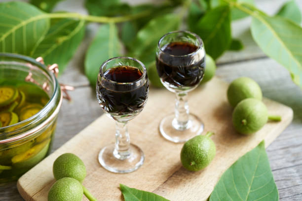 Two glasses of homemade nut liqueur made from unripe walnuts stock photo