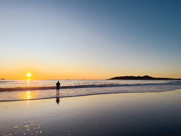 istock Fisherman on the Beach at Sunrise 1410433427
