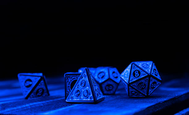 istock RPG dice illuminated with colored light, light painting style photo, selective focus. 1410433519