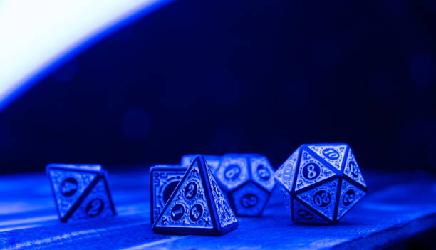 istock RPG dice illuminated with colored light, light painting style photo, selective focus. 1410433525