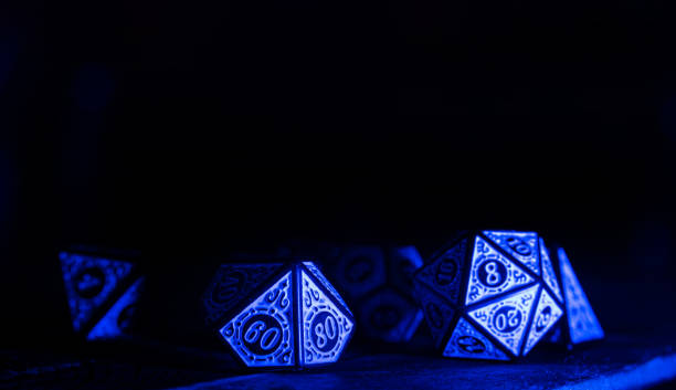 istock RPG dice illuminated with colored light, light painting style photo, selective focus. 1410433533