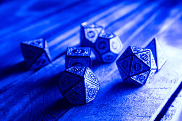 istock RPG dice illuminated with colored light, light painting style photo, selective focus. 1410433543