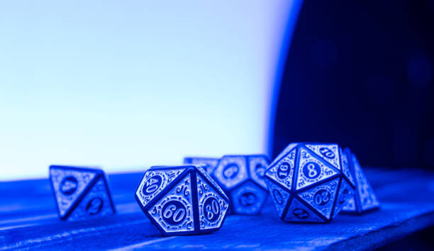 istock RPG dice illuminated with colored light, light painting style photo, selective focus. 1410433544