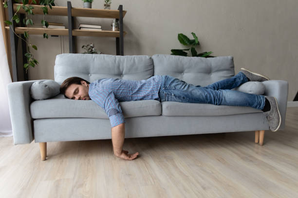 istock Exhausted young man fell asleep on comfortable couch. 1410433630