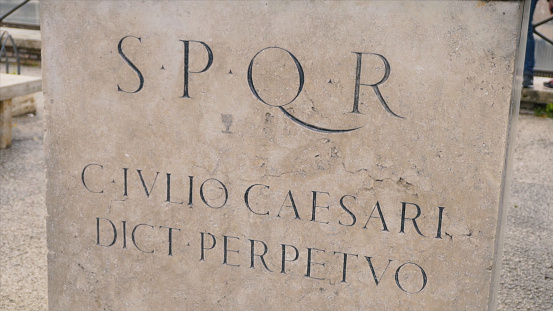 Roman writing and bas-reliefs imperial era archeology italy. Stock. SPQR inscription on the wall.