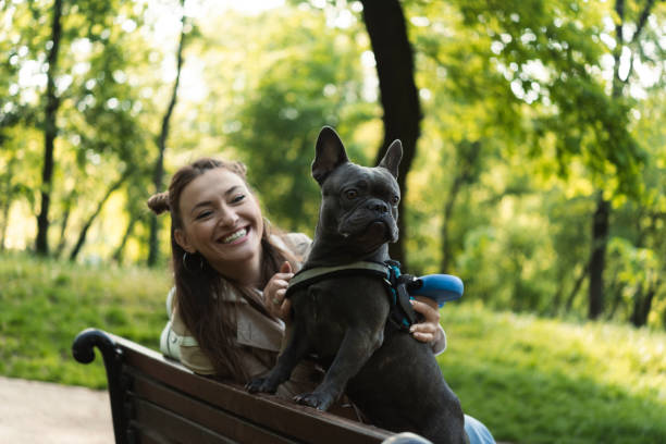 istock Young woman playing with dog 1410436223