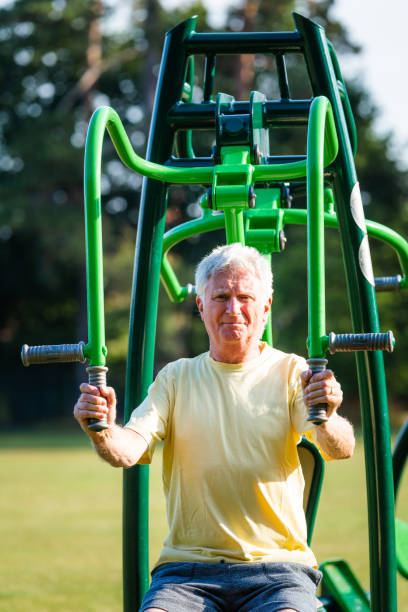istock Senior man working out using gym machines outdoors in park 1410436245