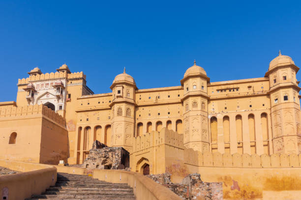 A photo of the front of the Amber Fort in Jaipur, India A view of the beautiful Amber Fort on a sunny day in Jaipur, Rajasthan, India. amber fort stock pictures, royalty-free photos & images