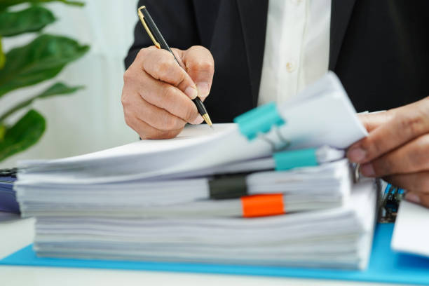 istock Businessman working and prepare paperwork report data to analysis information in file binder at office. 1410439160