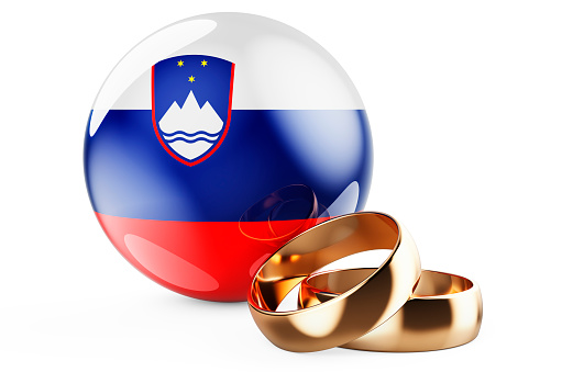 Weddings in Slovenia concept. Wedding rings with Slovenian flag. 3D rendering isolated on white background