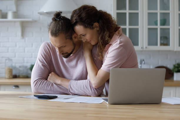 istock Unhappy young woman supporting stressed husband, having financial problems. 1410442370