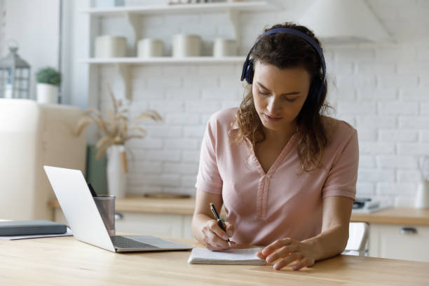 istock Concentrated young 30s woman e-learning at home. 1410442567