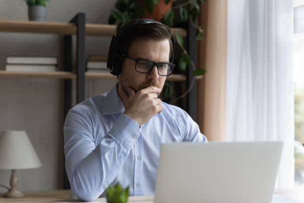 istock Focused young businessman holding video call meeting. 1410444804