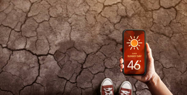 istock Water Crisis Concept. Environmental Impact. Global Issues in Agricultural. Standing on Cracked Soil with High Temperature Weather on Mobile Phone. Desertification, Pollution, Energy and Climate Change 1410448089